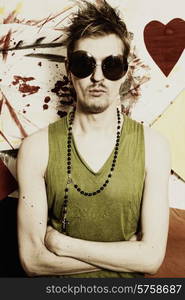 Portrait of a young punk man wearing sunglasses