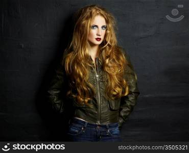Portrait of a young redheaded woman in a leather jacket