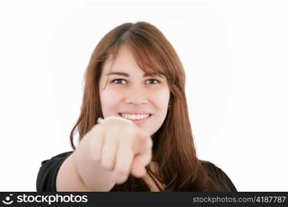Portrait of a young smiling businesswoman pointing at you. Isolated on white. Focus on woman