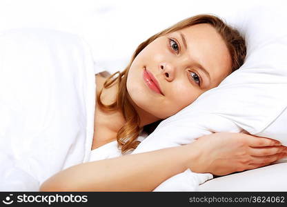 Portrait of a young smiling girl in bed