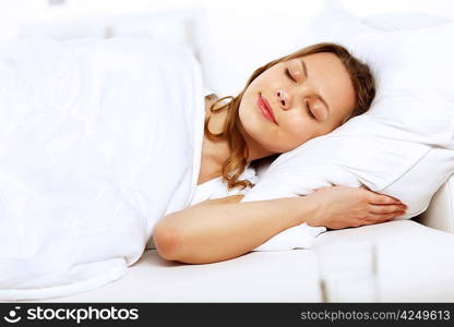 Portrait of a young smiling girl in bed