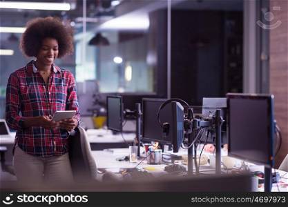 portrait of a young successful African American beautiful woman who enjoys spending a quality and joyful time while working in a large modern office