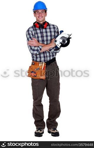 Portrait of a young tradesman holding a circular saw