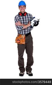 Portrait of a young tradesman holding a circular saw