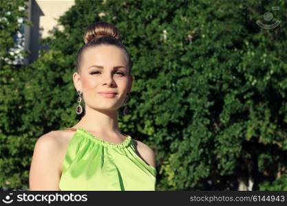 portrait of a young, well-groomed beautiful, glamorous woman on the walk. Outdoors