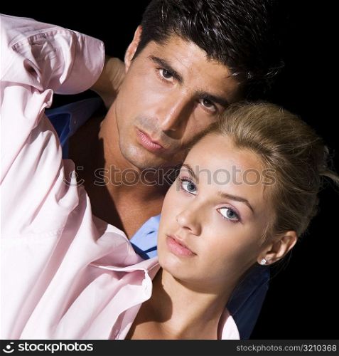 Portrait of a young woman and a mid adult man embracing each other