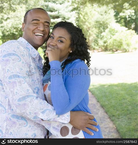 Portrait of a young woman and a mid adult man embracing to each other