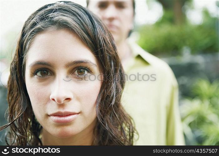 Portrait of a young woman and a mid adult man looking at each other