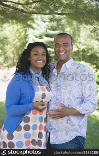 Portrait of a young woman and a mid adult man standing together and smiling