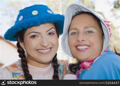 Portrait of a young woman and a mid adult woman smiling
