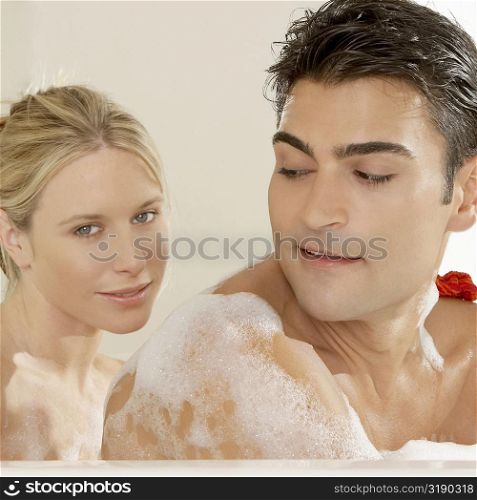 Portrait of a young woman and a young man in a bathtub