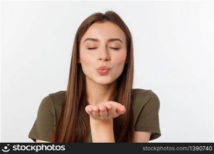 Portrait of a young woman blowing a kiss isolated over white. Portrait of a young woman blowing a kiss isolated over white.