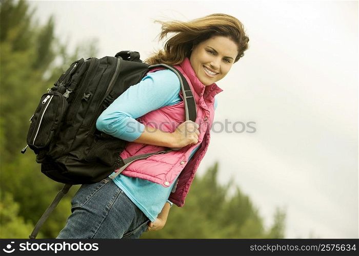 Portrait of a young woman carrying a backpack
