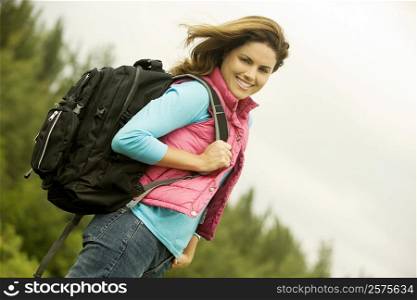 Portrait of a young woman carrying a backpack