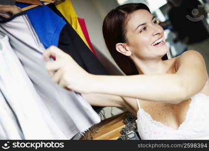 Portrait of a young woman choosing clothes in a clothing store