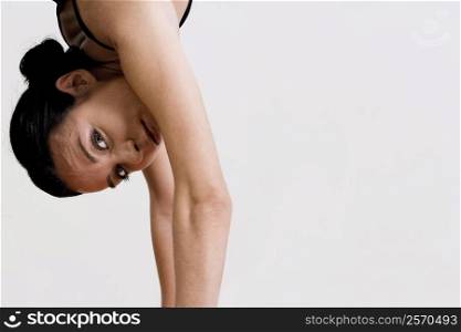 Portrait of a young woman doing a hand stand