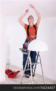 portrait of a young woman doing electricity work