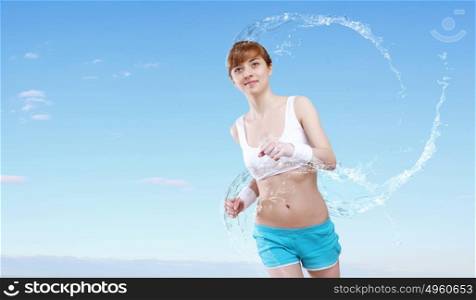 Portrait of a young woman doing sport with a bottle of pure water. Portrait of a young woman doing sport