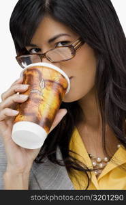 Portrait of a young woman drinking cold drink