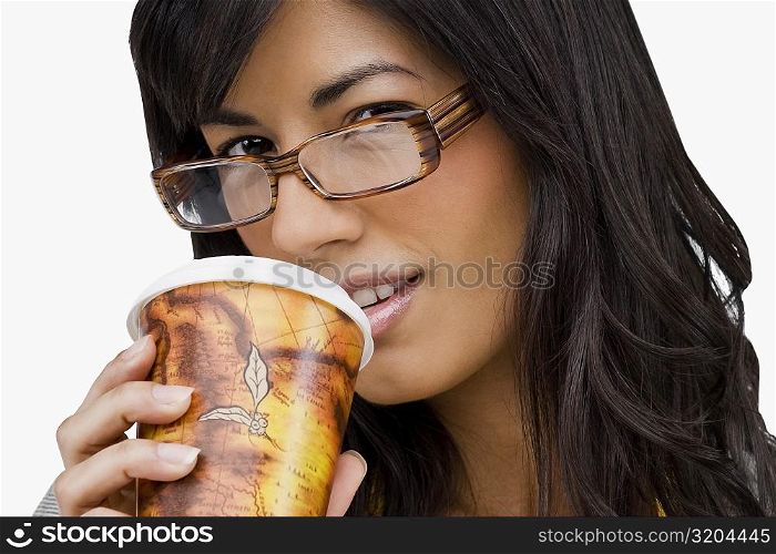 Portrait of a young woman drinking cold drink