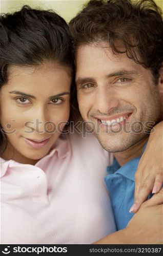 Portrait of a young woman embracing a mid adult man