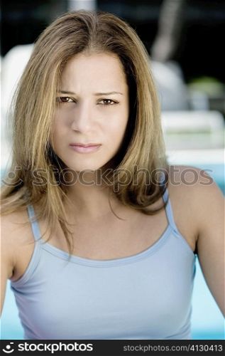 Portrait of a young woman frowning