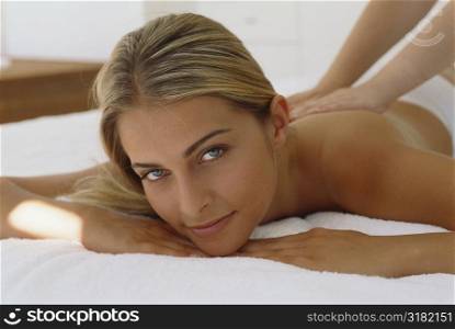 Portrait of a young woman getting a back massage