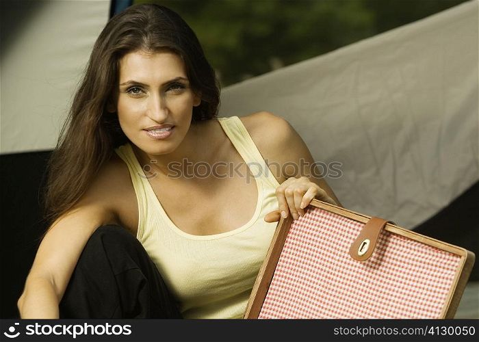 Portrait of a young woman holding a briefcase