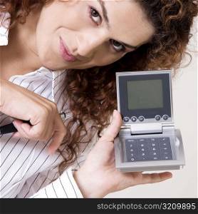 Portrait of a young woman holding a calculator