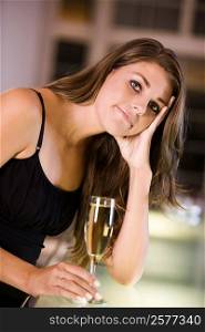 Portrait of a young woman holding a champagne flute