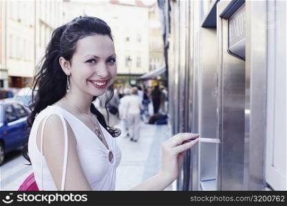 Portrait of a young woman holding a credit card