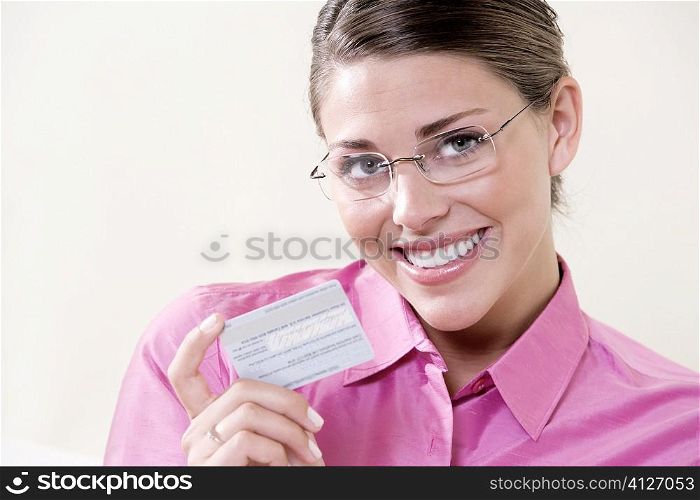 Portrait of a young woman holding a credit card