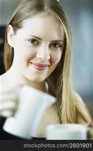 Portrait of a young woman holding a cup of tea