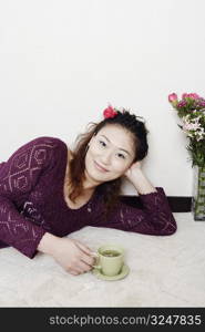 Portrait of a young woman holding a cup of tea