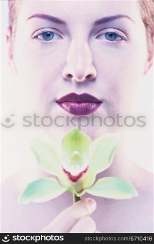 Portrait of a young woman holding a flower