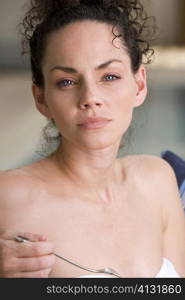 Portrait of a young woman holding a fork