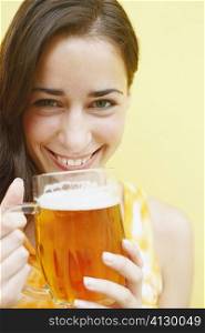 Portrait of a young woman holding a glass of beer