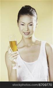 Portrait of a young woman holding a glass of champagne