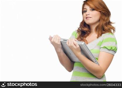 Portrait of a young woman holding a laptop