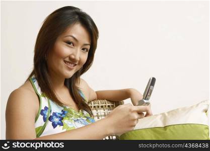 Portrait of a young woman holding a mobile phone