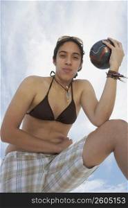Portrait of a young woman holding a soccer ball
