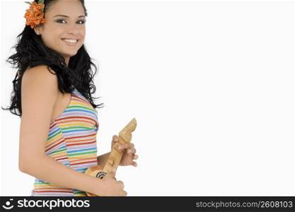 Portrait of a young woman holding a ukulele