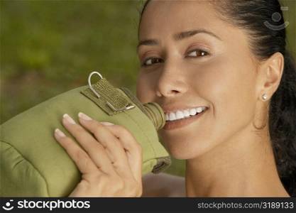 Portrait of a young woman holding a water bottle