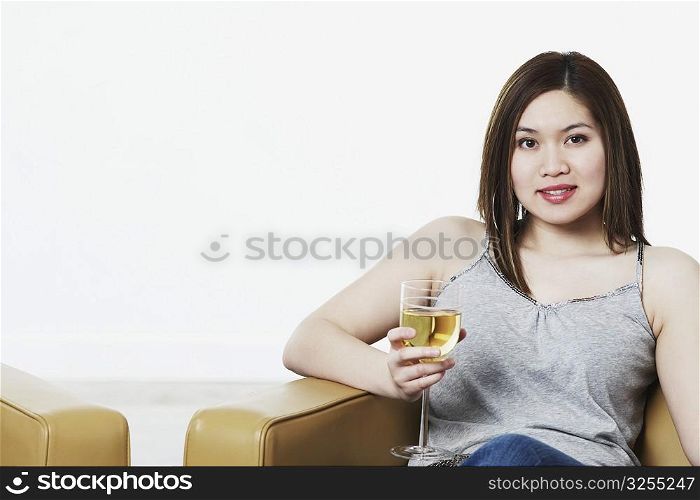 Portrait of a young woman holding a wineglass