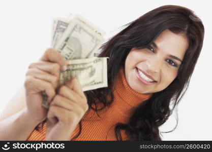 Portrait of a young woman holding American dollar bills
