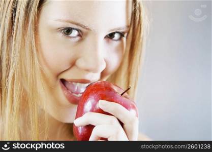 Portrait of a young woman holding an apple