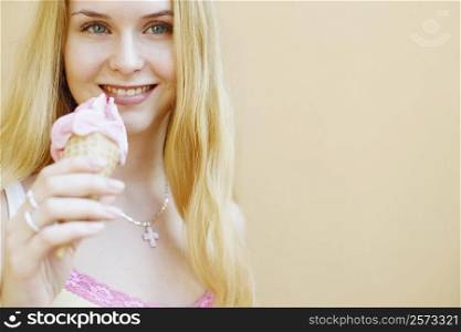 Portrait of a young woman holding an ice-cream cone