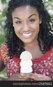 Portrait of a young woman holding an ice cream cone