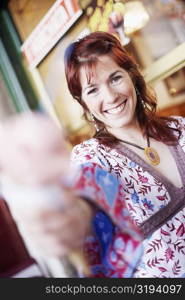 Portrait of a young woman holding an ice-cream cone