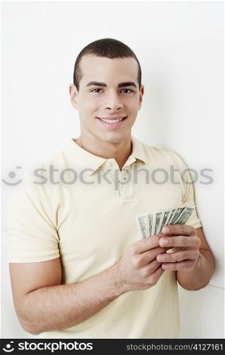 Portrait of a young woman holding dollar bills